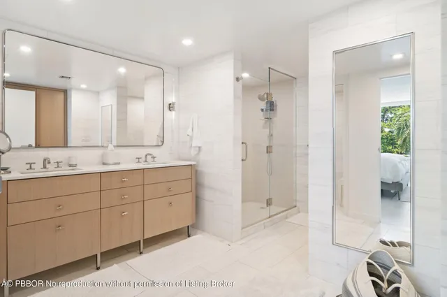 a bathroom with a double vanity sink mirror and shower