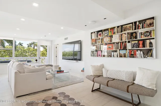 a living room with furniture and a book shelf