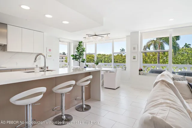 a kitchen with a table chairs sink and cabinets
