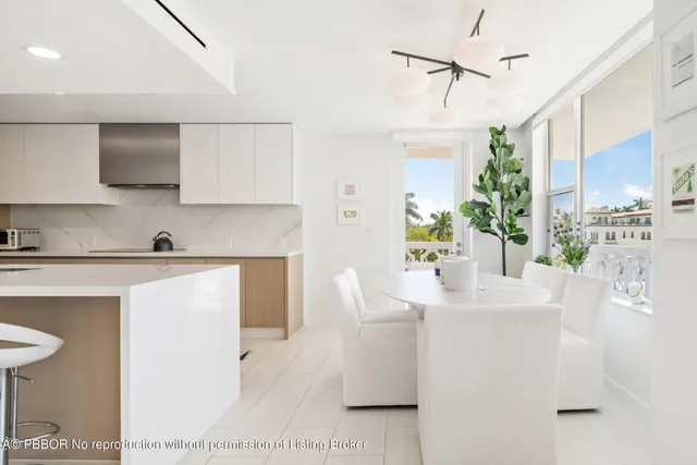 a view of living room with stainless steel appliances kitchen island granite countertop furniture and a fireplace