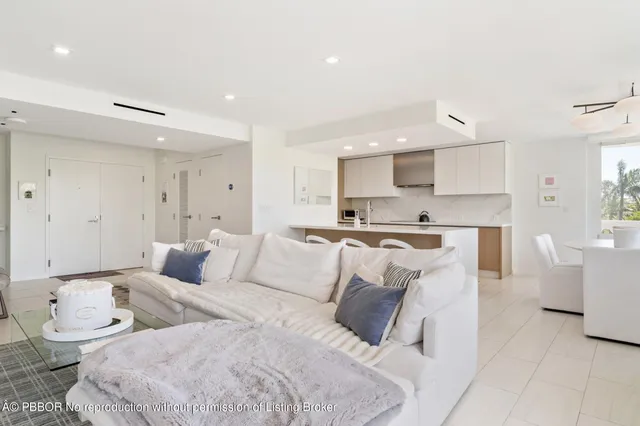 a living room with furniture and kitchen view