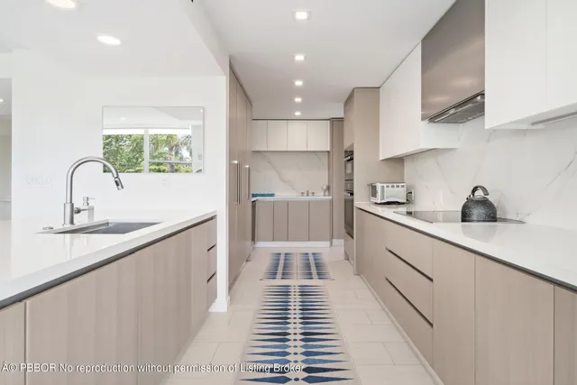 a kitchen with cabinets a sink and appliances