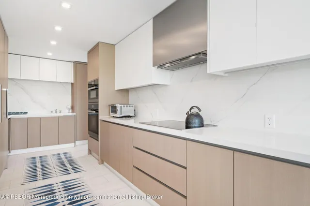 a kitchen with kitchen island granite countertop a sink stainless steel appliances and cabinets