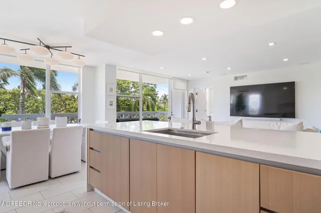 a kitchen with stainless steel appliances white cabinets and a large window