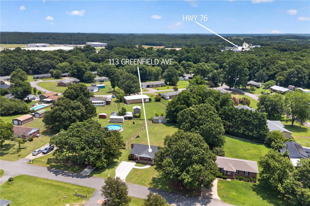113 Greenfield Avenue Pendleton, SC 29670 - Photo 33 of 40 An aerial perspective reveals a private residence nestled amongst mature trees and a sprawling green lawn.