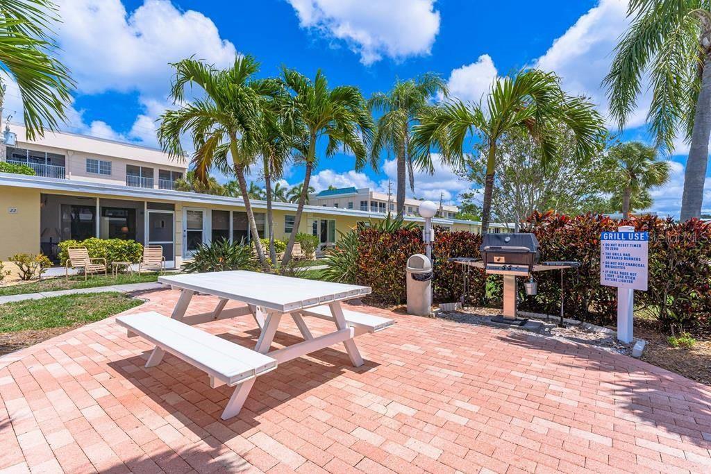 6006 Midnight Pass Road, Unit 29 Sarasota, FL 34242 - Photo 11 of 19 a view of a chairs and table in backyard of the house
