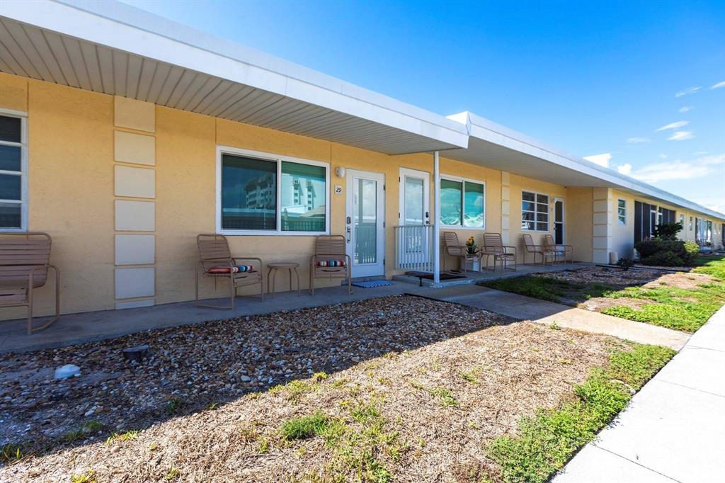 6006 Midnight Pass Road, Unit 29 Sarasota, FL 34242 - Photo 8 of 19 a front view of a house with garden