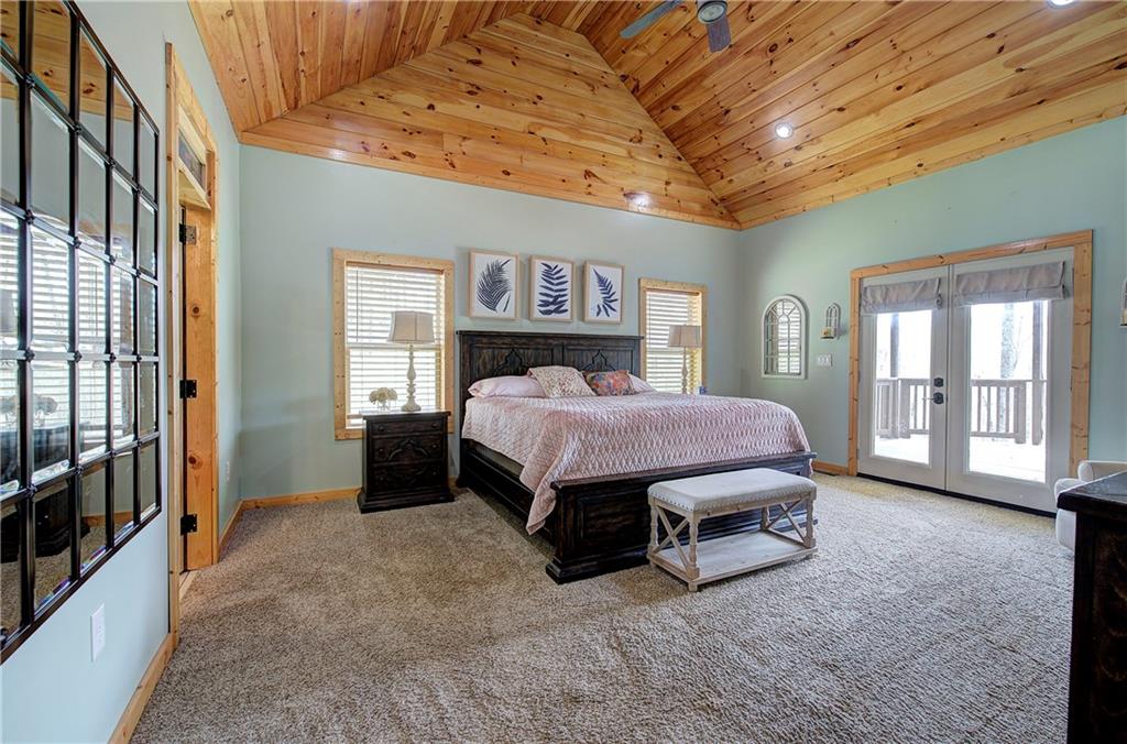 100 Buckwood Farms Path Dallas, GA 30132 - Photo 12 of 70 a spacious bedroom with a bed and a large window with balcony view