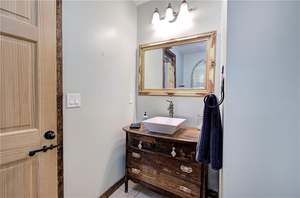 100 Buckwood Farms Path Dallas, GA 30132 - Photo 14 of 70 a bathroom with a sink a vanity and a mirror