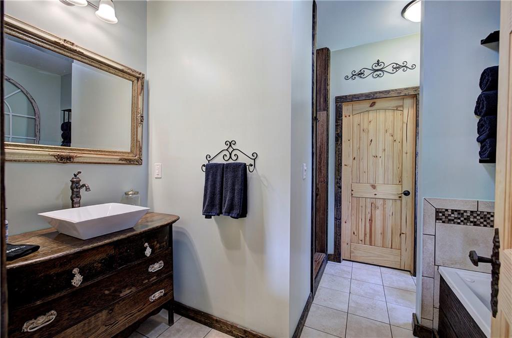 100 Buckwood Farms Path Dallas, GA 30132 - Photo 15 of 70 a bathroom with a sink a mirror and shower