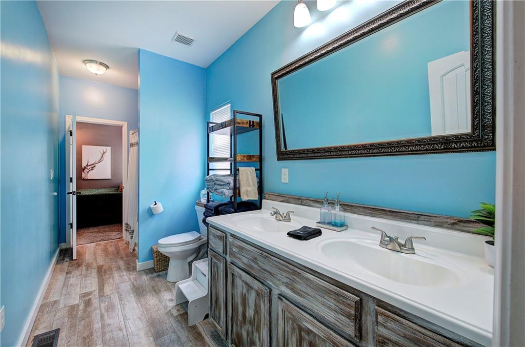 100 Buckwood Farms Path Dallas, GA 30132 - Photo 19 of 70 a bathroom with a sink a toilet and a mirror