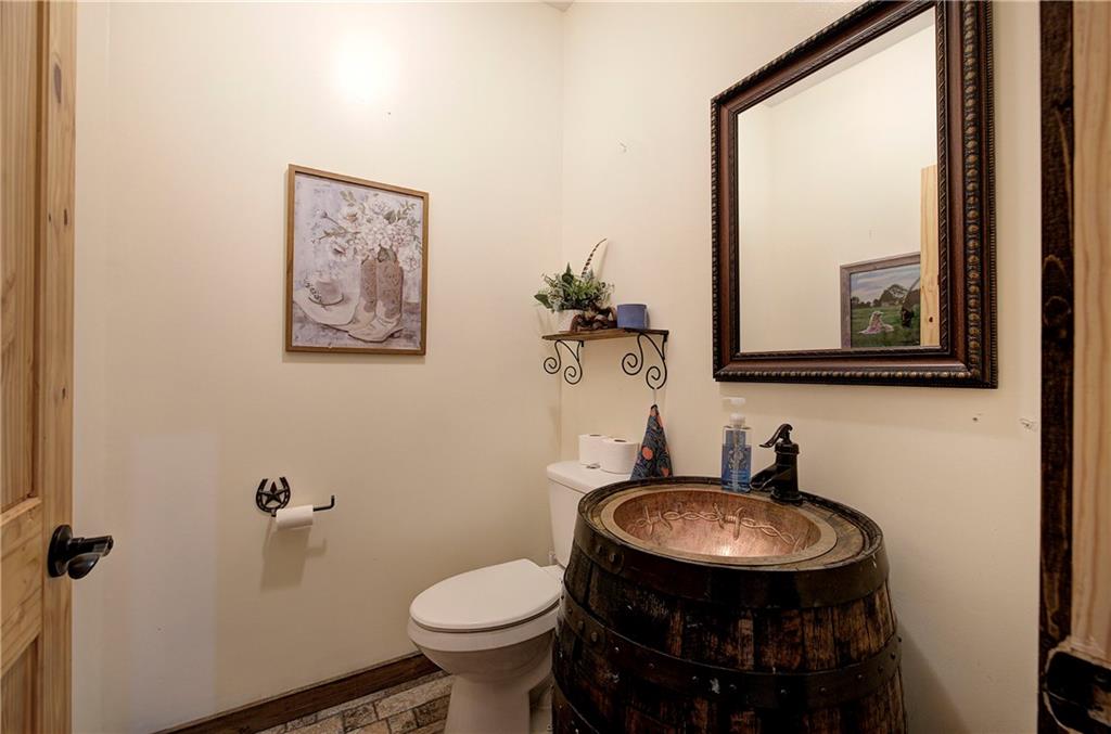 100 Buckwood Farms Path Dallas, GA 30132 - Photo 24 of 70 a bathroom with a toilet sink and mirror