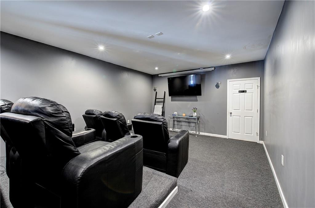 100 Buckwood Farms Path Dallas, GA 30132 - Photo 29 of 70 a living room with furniture and a flat screen tv