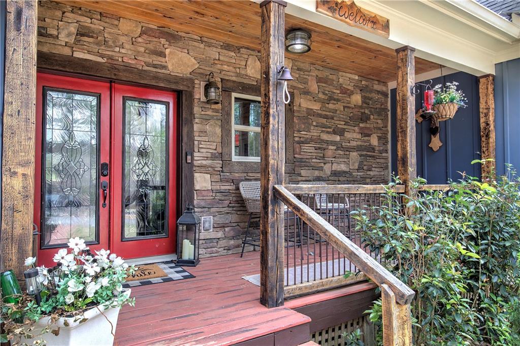 100 Buckwood Farms Path Dallas, GA 30132 - Photo 4 of 70 a view of a brick house with flower plants
