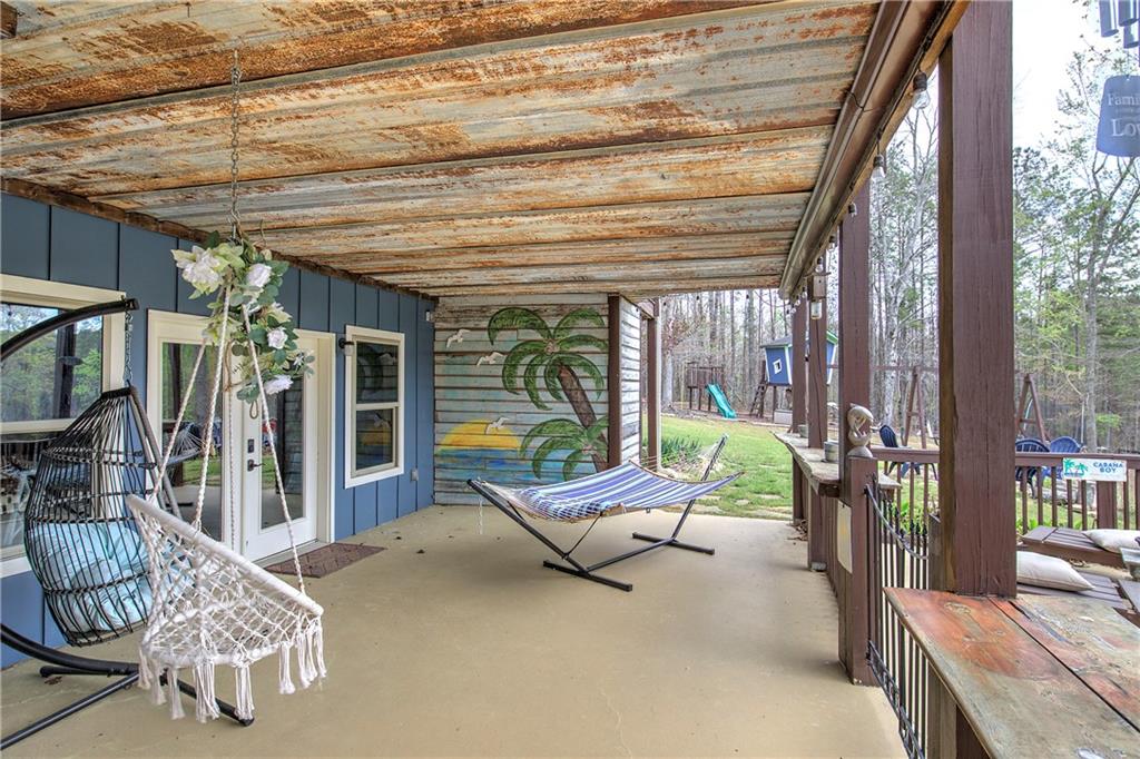 100 Buckwood Farms Path Dallas, GA 30132 - Photo 56 of 70 a view of a patio with a dining table and chairs