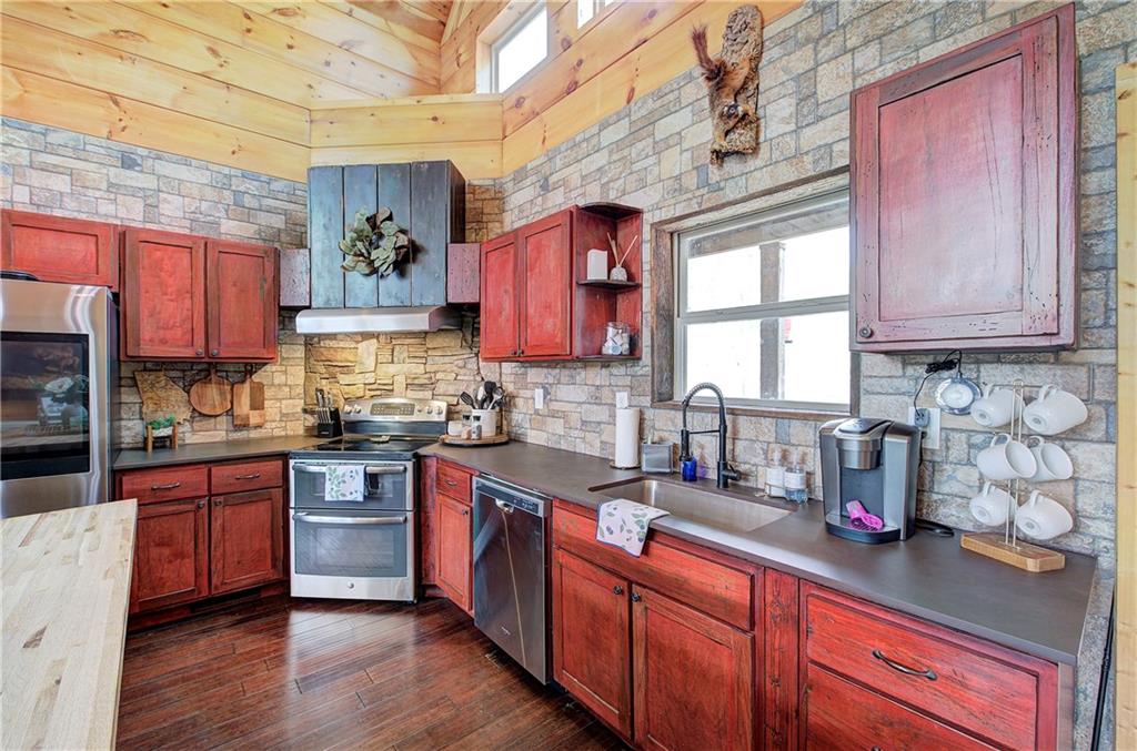 100 Buckwood Farms Path Dallas, GA 30132 - Photo 6 of 70 a kitchen with stainless steel appliances granite countertop wooden cabinets a sink and dishwasher