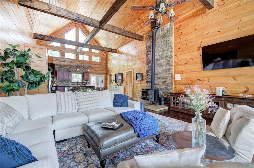 100 Buckwood Farms Path Dallas, GA 30132 - Photo 10 of 70 a living room with furniture a flat screen tv and a fireplace