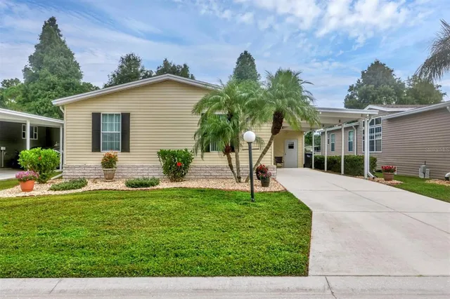 a view of a house with a yard and a patio