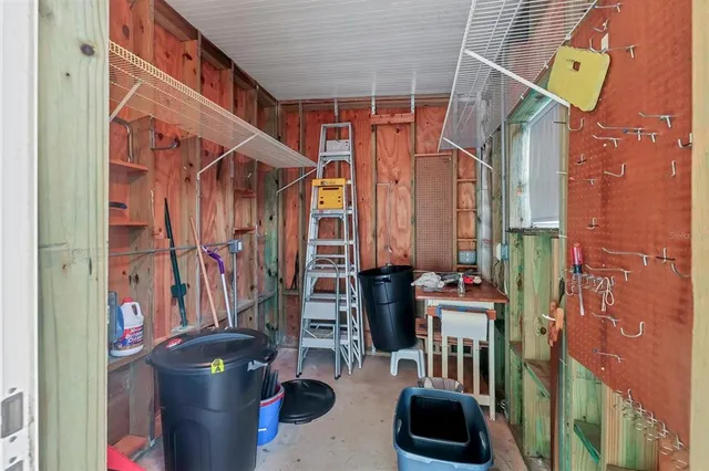 a view of a lake with a yard and large trees