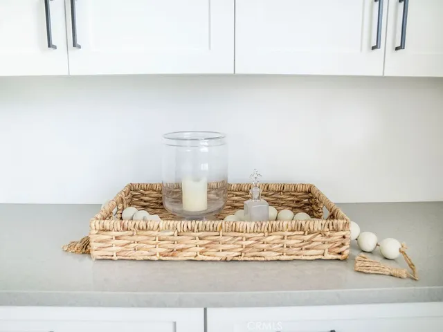 a kitchen with granite countertop white cabinets and white appliances