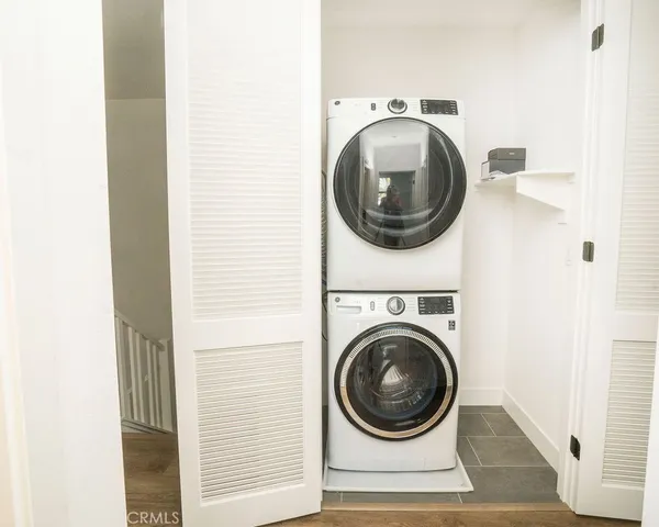a front view of a house with a yard and potted plants