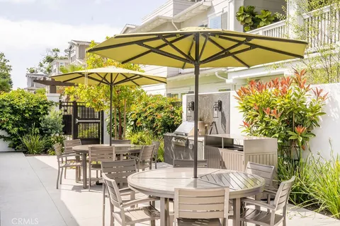 a view of a patio with a dining table and chairs
