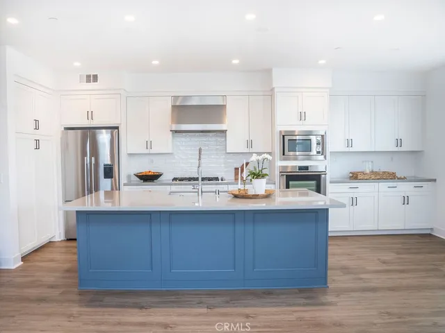 a view of a sink with wooden cabinets