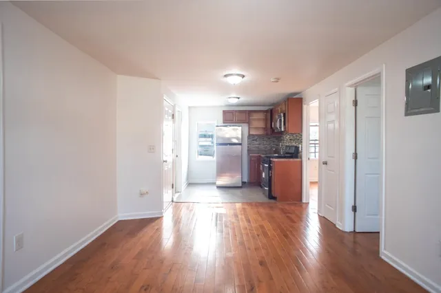 a view of a kitchen with wooden floor
