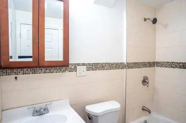 a bathroom with a toilet a sink and bathtub