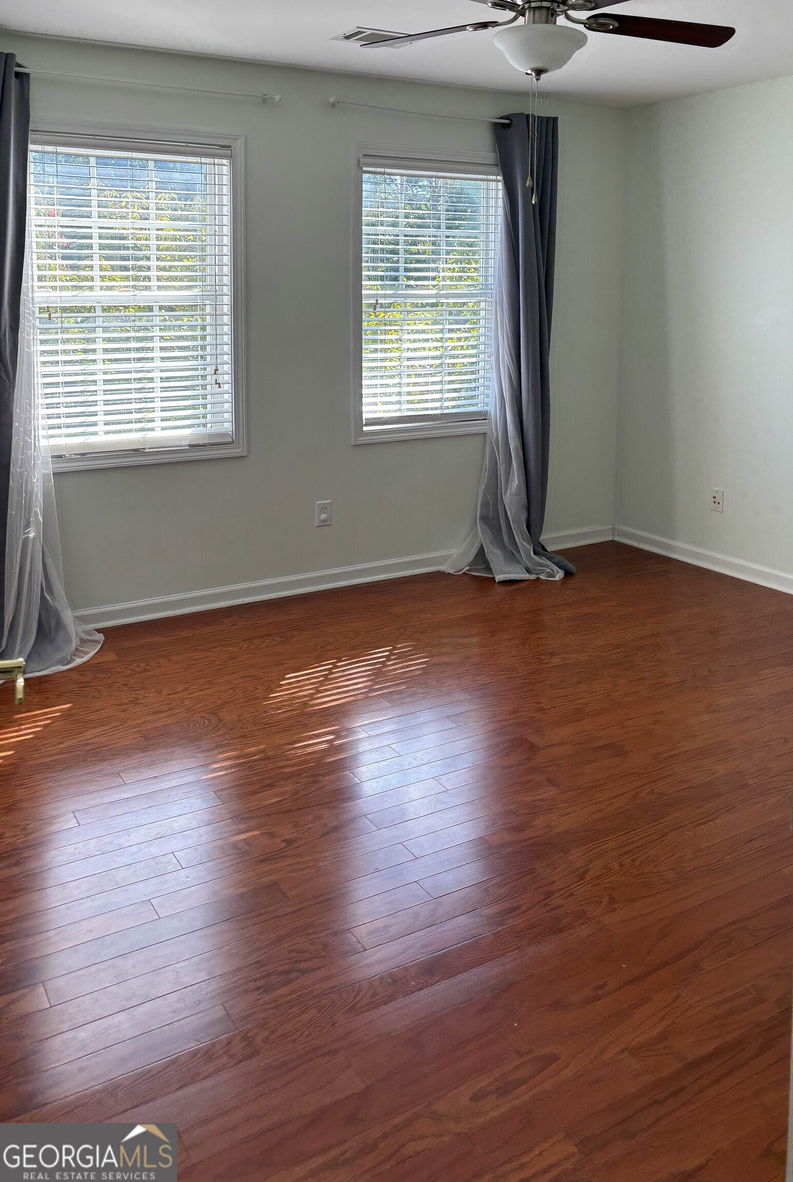 38 The Promenade Newnan, GA 30265 - Photo 14 of 22 an empty room with wooden floor and windows