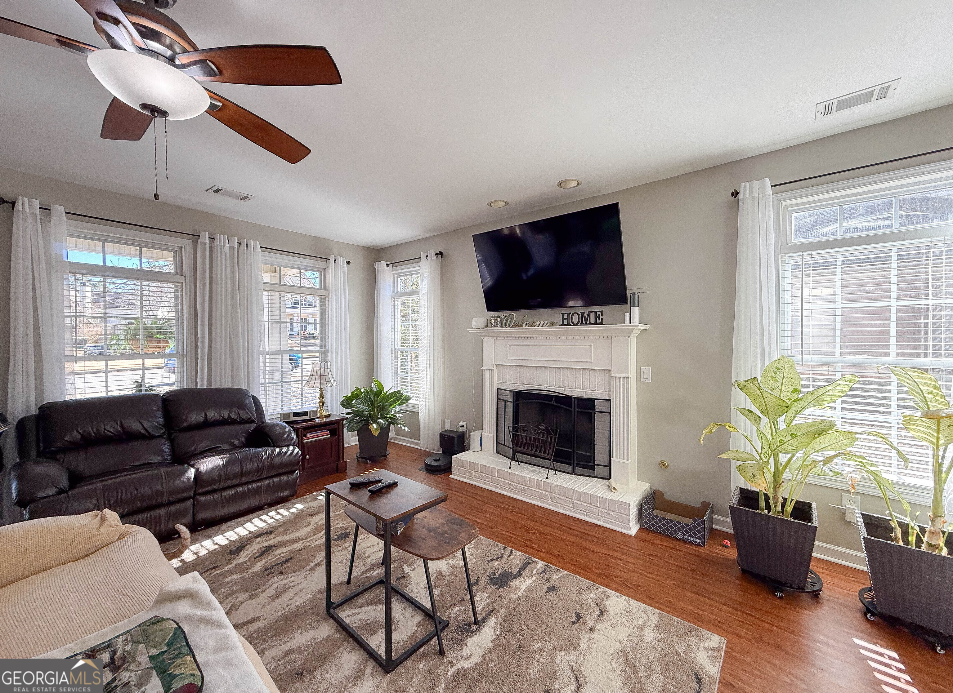 38 The Promenade Newnan, GA 30265 - Photo 3 of 22 a living room with furniture a flat screen tv and a fireplace