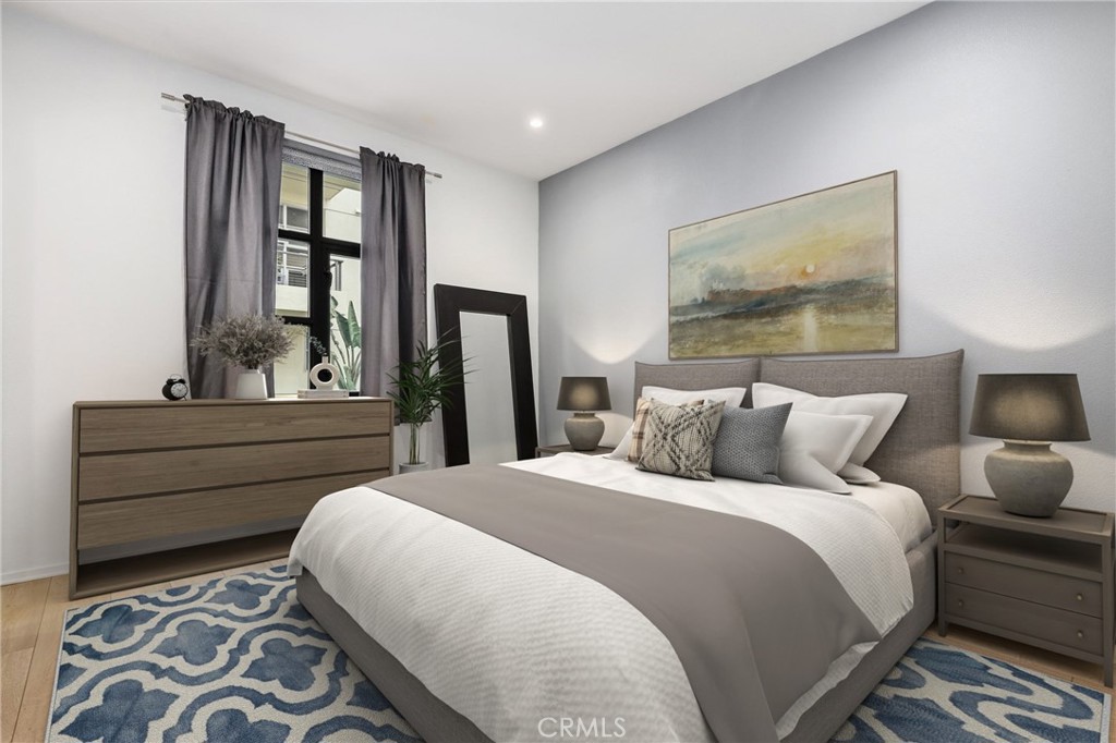 133 The Promenade North, Unit 118 Long Beach, CA 90802 - Photo 14 of 35 a bedroom with a large bed and a window