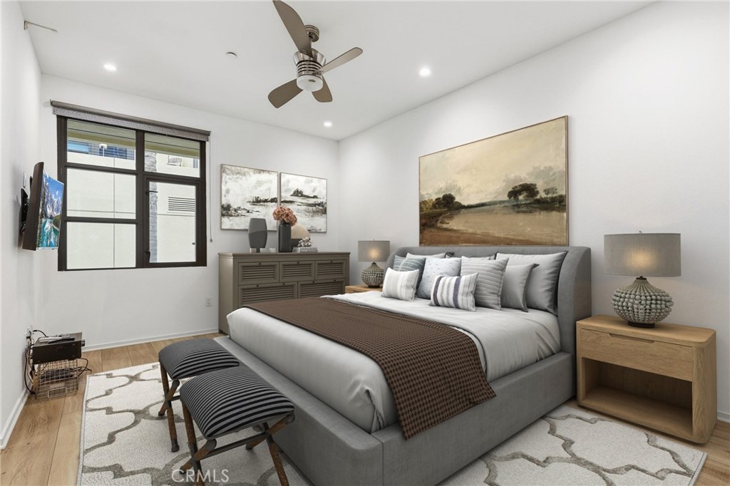 133 The Promenade North, Unit 118 Long Beach, CA 90802 - Photo 15 of 35 a bedroom with a bed and wooden floor