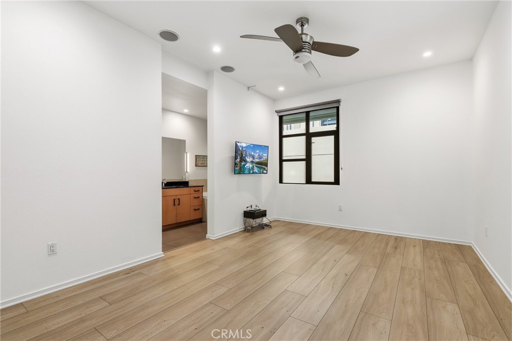 133 The Promenade North, Unit 118 Long Beach, CA 90802 - Photo 16 of 35 an empty room with windows and ceiling fan