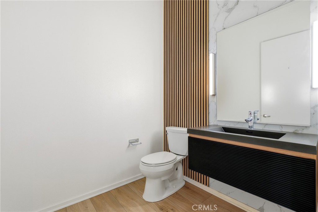 133 The Promenade North, Unit 118 Long Beach, CA 90802 - Photo 21 of 35 a bathroom with a granite countertop toilet and sink