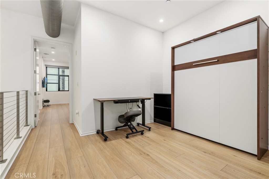 133 The Promenade North, Unit 118 Long Beach, CA 90802 - Photo 22 of 35 a view of room with wooden floor and furniture