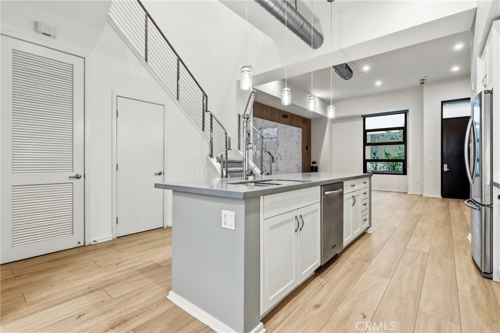 133 The Promenade North, Unit 118 Long Beach, CA 90802 - Photo 9 of 35 a kitchen with granite countertop a white stove top oven and cabinets