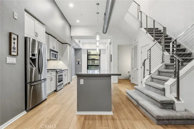 a kitchen with white cabinets and sink