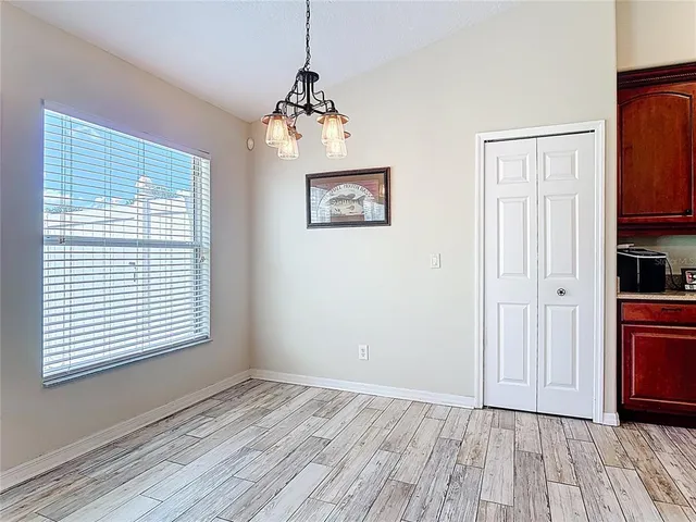 a view of kitchen with windows and refrigerator