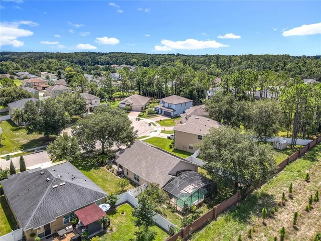 an aerial view of residential houses with outdoor space and river