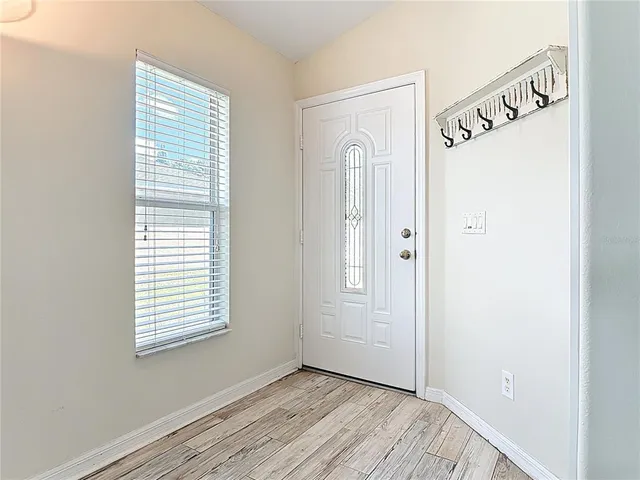 a view of an entryway with wooden floor