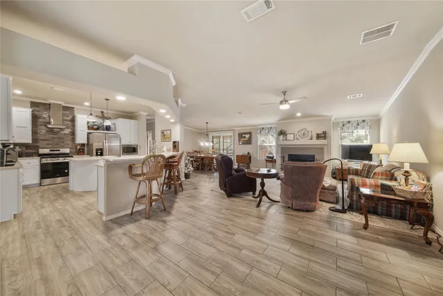 a living room with lots of furniture and kitchen view