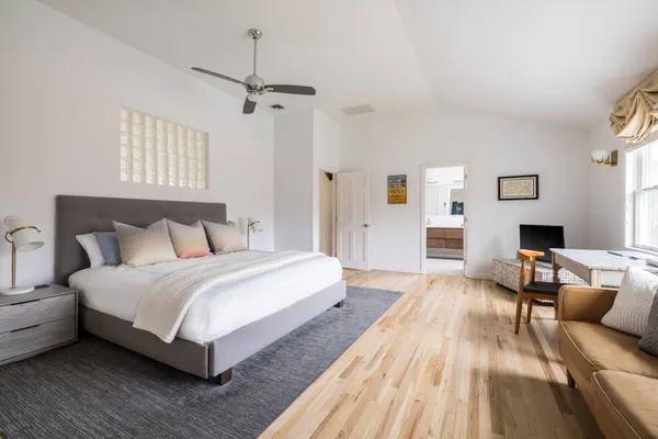 a bedroom with a bed and a window