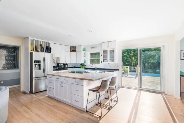 a bathroom with a tub sink and mirror