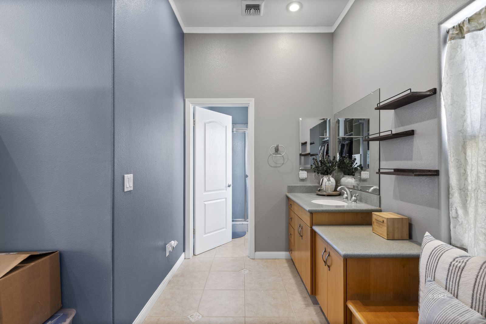 107 Brianna Street Ridgecrest, CA 93555 - Photo 27 of 50 a hallway with a sink and cabinets
