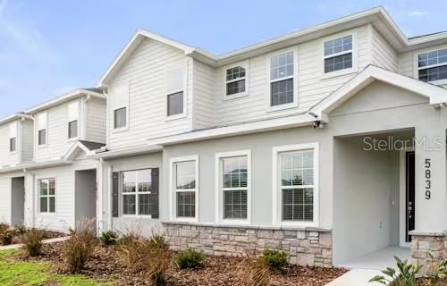 a view of brick house with a yard