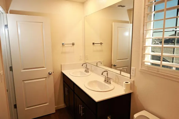 a bathroom with a sink vanity and a mirror
