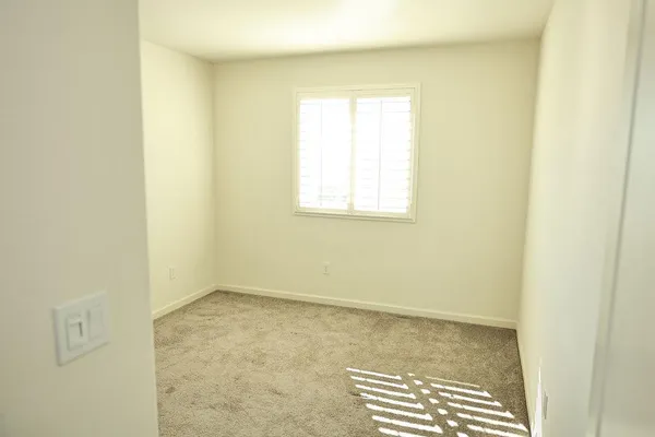 an empty room with windows and closet