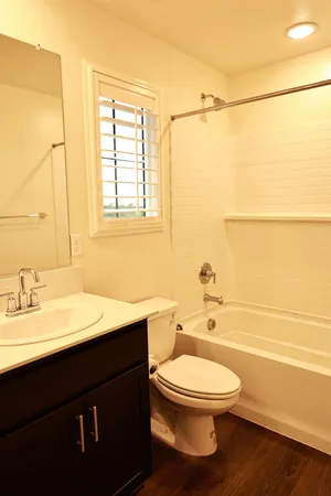 a bathroom with a granite countertop toilet and a sink