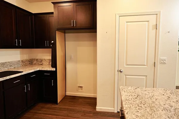 a kitchen with stainless steel appliances granite countertop a refrigerator a sink and a stove